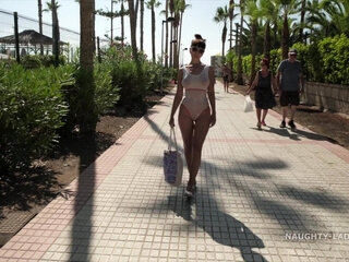 Busty MILF is walking almost naked on the public beach making everyone blush