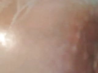 Steamy cougar plays with her hooters in the bathroom