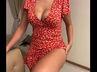 My stepmom is sitting in a red dress and showing her tits